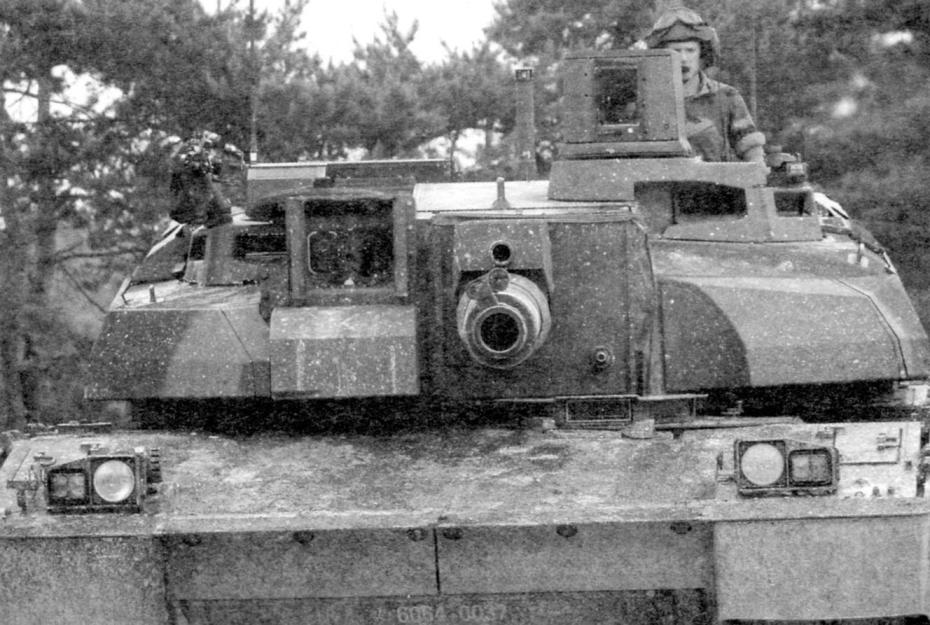 Башня танка с комбинированными прицелами командира HL70 и наводчика HL60 (на фото - слева от пушки). Над пушкой виден лазерный прибор датчика кривизны её ствола; 7,62-мм пулемёт находится в нижней части башни (на фото - справа от пушки)