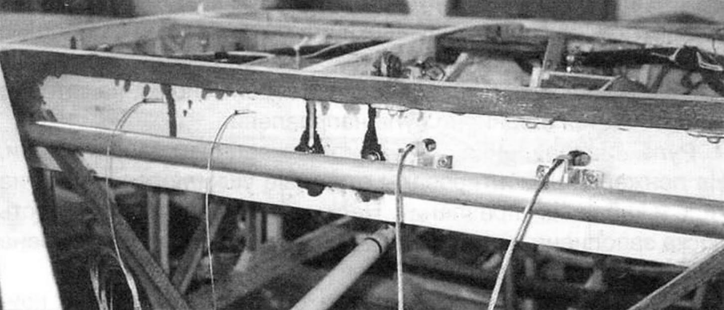 Rear center section spar (bottom view). Above, the main (long) elevator control rod runs across. Cables are passed through the spar: on the right (thinner) - control of the tail wheel; on the left - rudder control cables with nylon rollers to bypass the flap control shaft running along the spar
