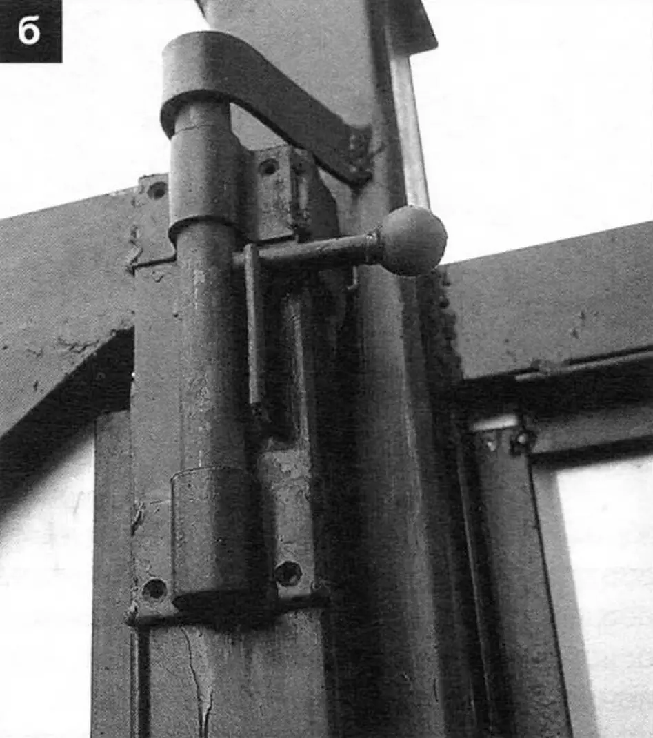 In closed position (see header) the gate frame is additionally held by the lower roller (a) on the left intermediate support post and upper bolt (b); gate travel is limited by a bolt resting against the upper retaining roller (c)