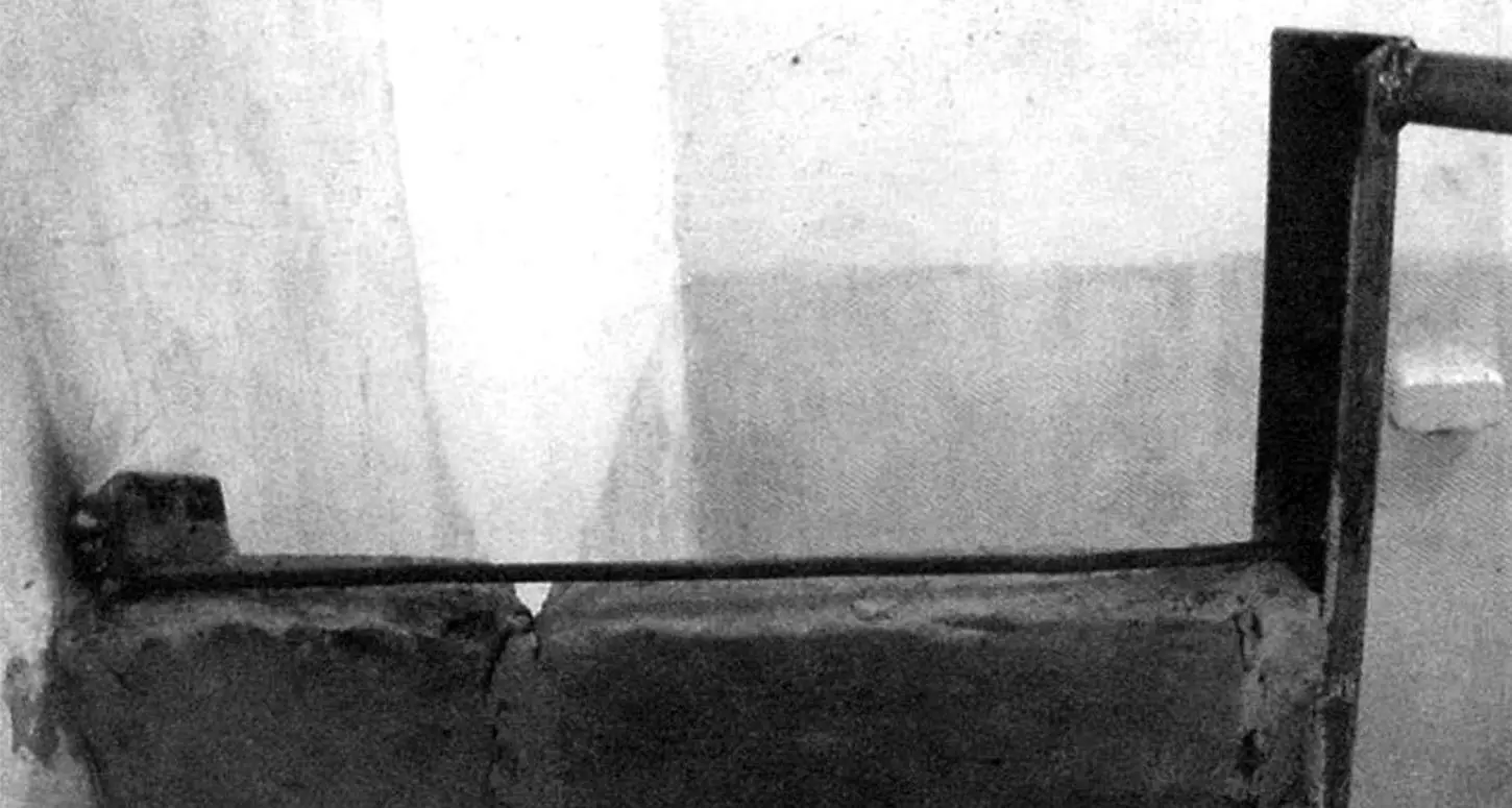 Installing a tie between the frame and wall posts in a mortar joint